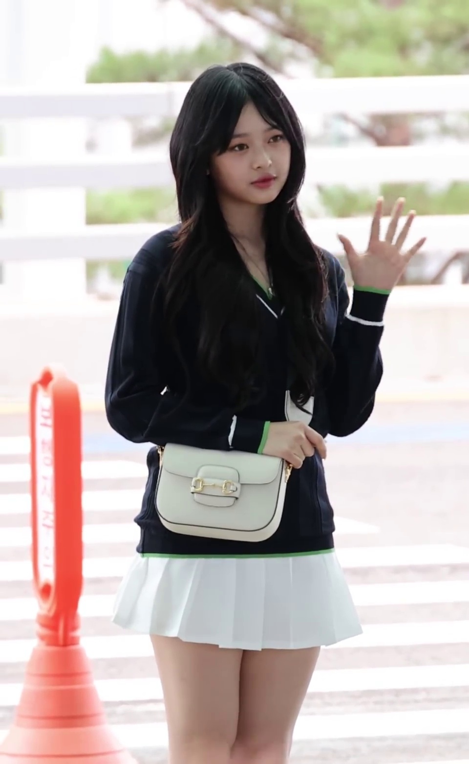 NewJeans Hanni's White Tennis Skirt and Fair Legs at Departure - Image 1